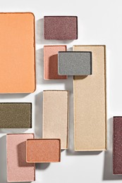 Photo of Beautiful eyeshadow refill pans on white background, flat lay