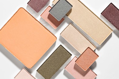 Photo of Beautiful eyeshadow refill pans on white background, flat lay