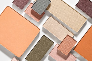 Photo of Beautiful eyeshadow refill pans on white background, flat lay