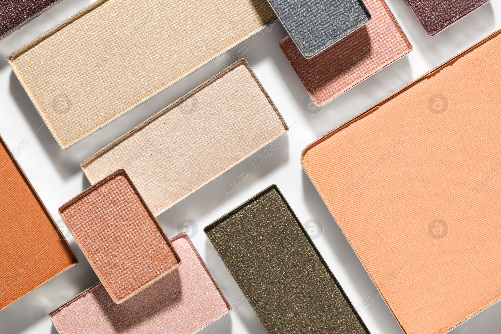 Beautiful eyeshadow refill pans on white background, flat lay Photo of Beautiful eyeshadow refill pans on white background, flat lay