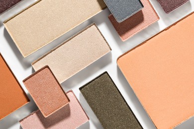 Photo of Beautiful eyeshadow refill pans on white background, flat lay