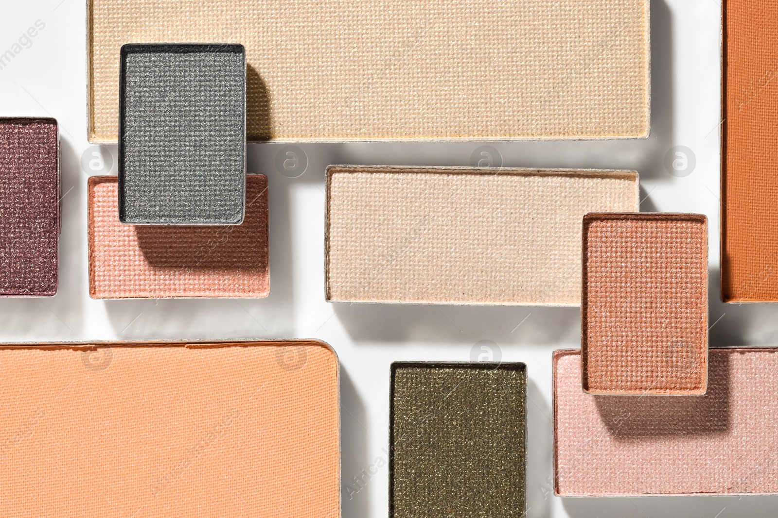 Beautiful eyeshadow refill pans on white background, flat lay Photo of Beautiful eyeshadow refill pans on white background, flat lay