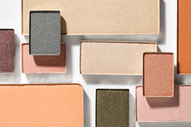 Photo of Beautiful eyeshadow refill pans on white background, flat lay