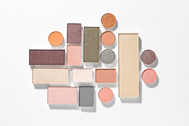 Photo of Beautiful eyeshadow refill pans on white background, flat lay