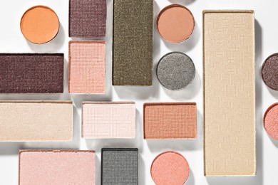 Photo of Beautiful eyeshadow refill pans on white background, flat lay