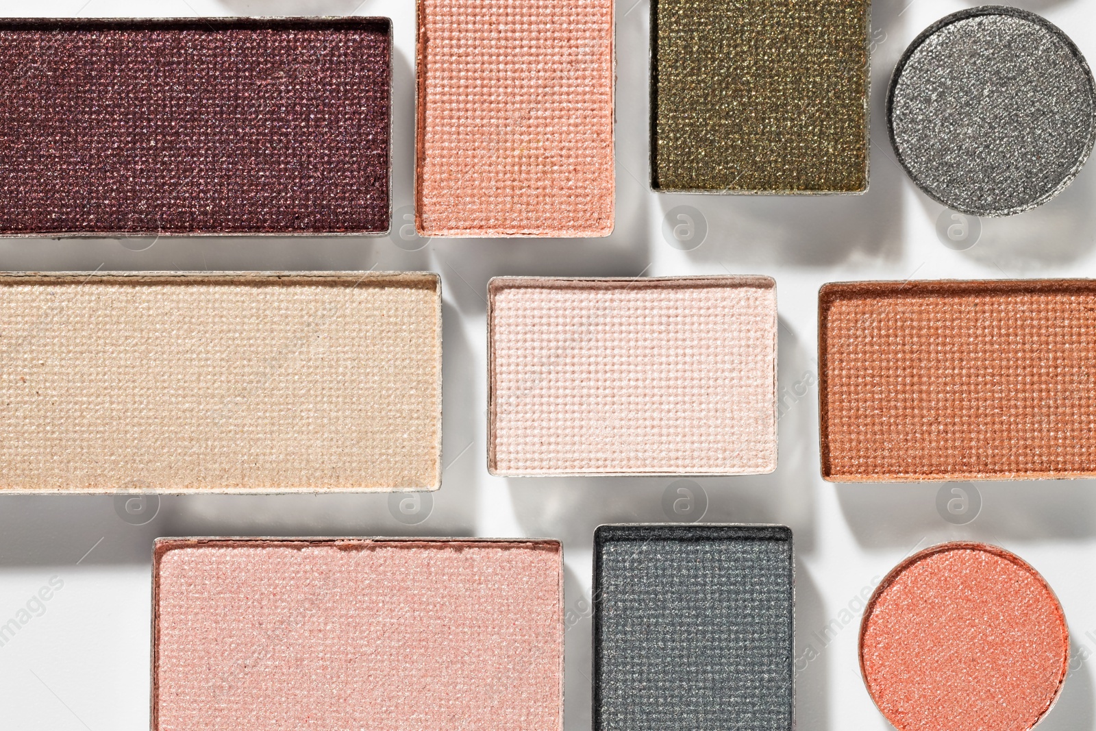 Beautiful eyeshadow refill pans on white background, flat lay Photo of Beautiful eyeshadow refill pans on white background, flat lay
