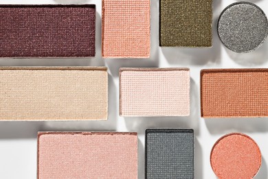 Photo of Beautiful eyeshadow refill pans on white background, flat lay