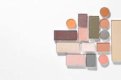 Photo of Beautiful eyeshadow refill pans on white background, flat lay. Space for text