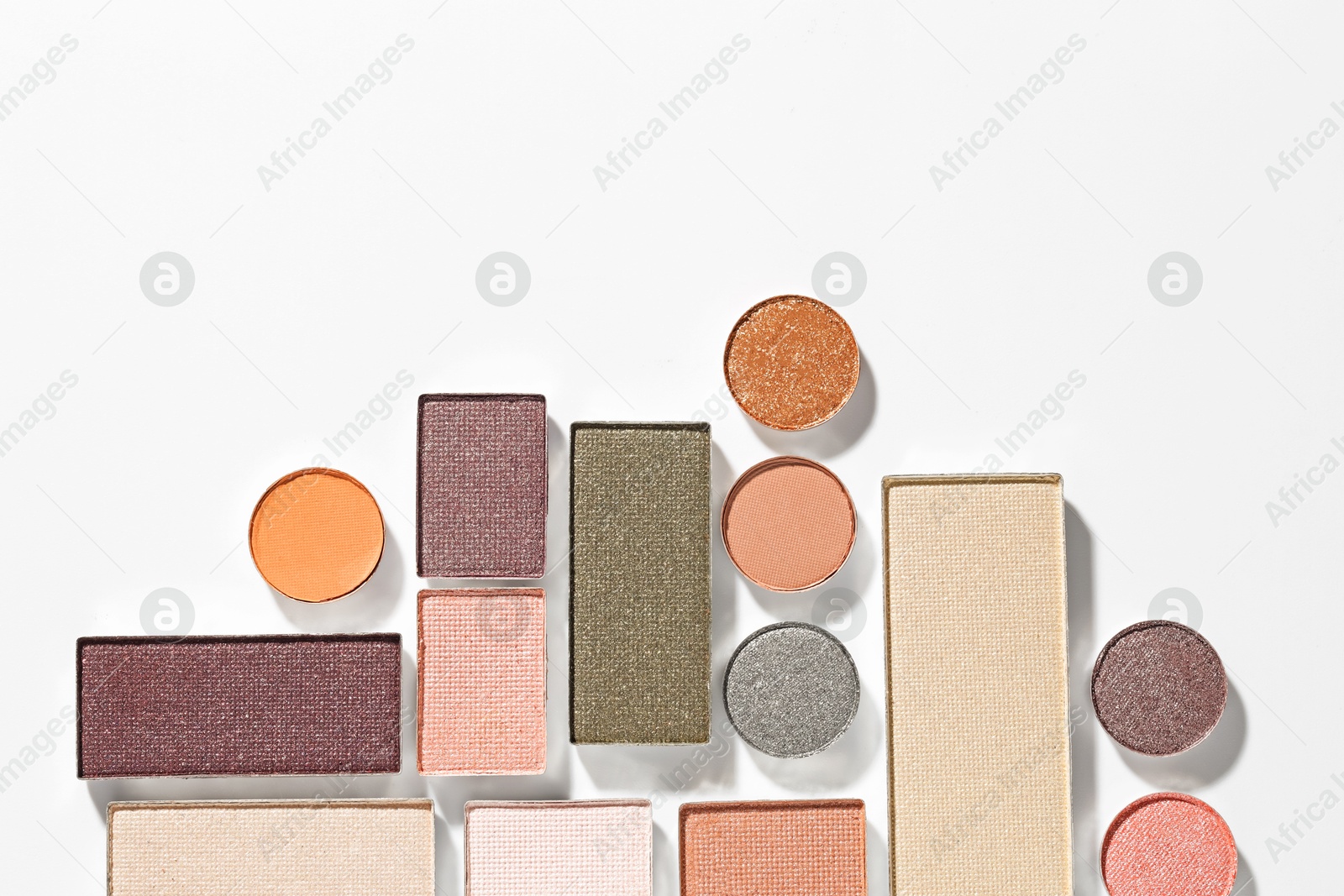 Beautiful eyeshadow refill pans on white background, flat lay. Space for text Photo of Beautiful eyeshadow refill pans on white background, flat lay. Space for text