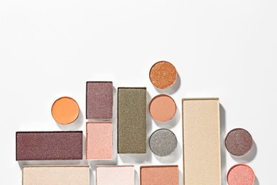 Photo of Beautiful eyeshadow refill pans on white background, flat lay. Space for text