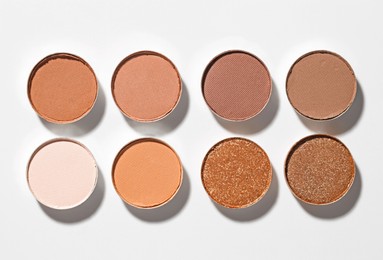 Photo of Beautiful eyeshadow refill pans on white background, flat lay