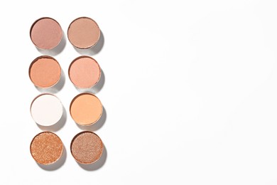 Photo of Beautiful eyeshadow refill pans on white background, flat lay. Space for text