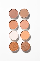 Photo of Beautiful eyeshadow refill pans on white background, flat lay
