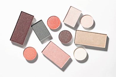 Photo of Beautiful eyeshadow refill pans on white background, flat lay