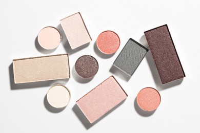 Photo of Beautiful eyeshadow refill pans on white background, flat lay