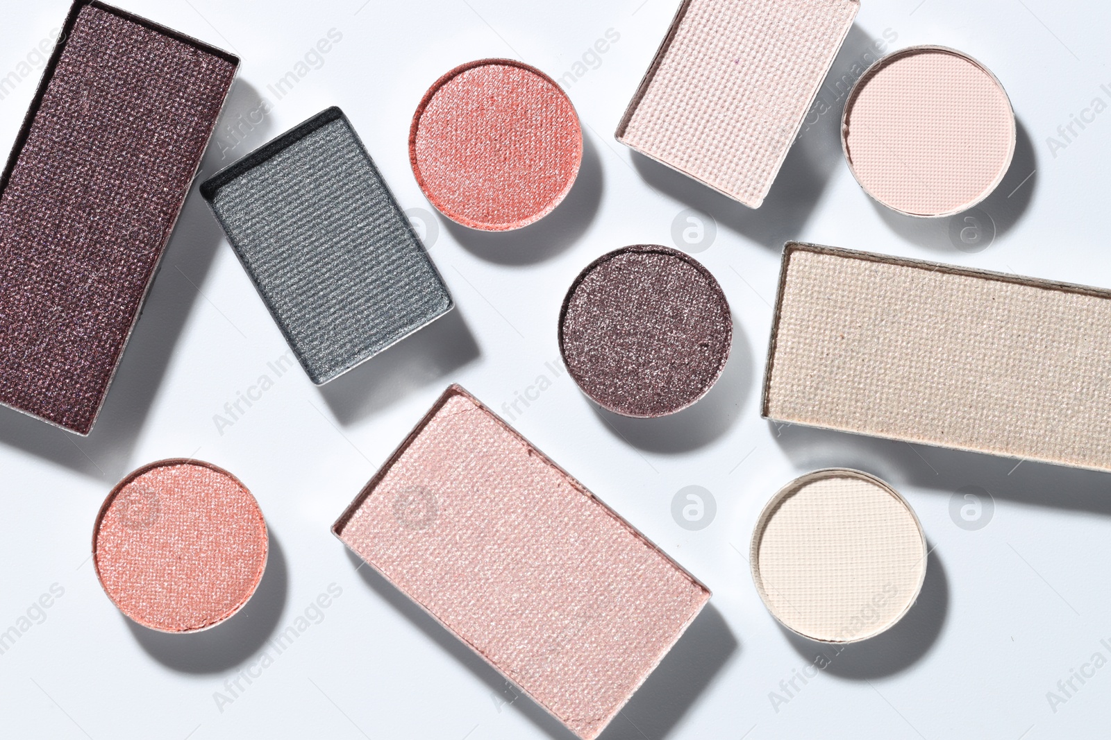 Beautiful eyeshadow refill pans on white background, flat lay Photo of Beautiful eyeshadow refill pans on white background, flat lay