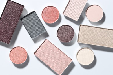 Photo of Beautiful eyeshadow refill pans on white background, flat lay