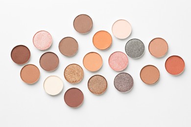 Photo of Beautiful eyeshadow refill pans on white background, flat lay