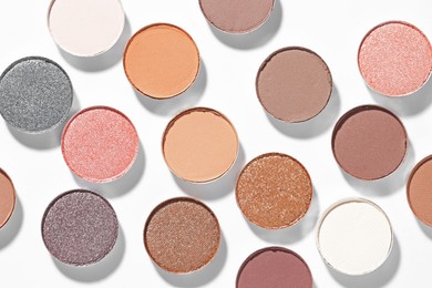 Photo of Beautiful eyeshadow refill pans on white background, flat lay