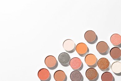 Photo of Beautiful eyeshadow refill pans on white background, flat lay. Space for text