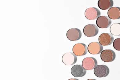 Photo of Beautiful eyeshadow refill pans on white background, flat lay. Space for text