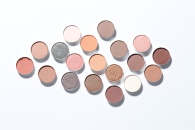 Photo of Beautiful eyeshadow refill pans on white background, flat lay