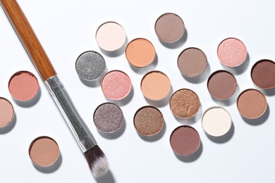 Photo of Beautiful eyeshadow refill pans and brush on white background, flat lay