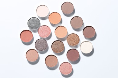 Photo of Beautiful eyeshadow refill pans on white background, flat lay