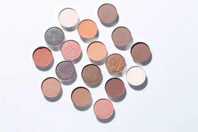 Photo of Beautiful eyeshadow refill pans on white background, flat lay