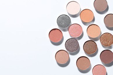 Photo of Beautiful eyeshadow refill pans on white background, flat lay. Space for text