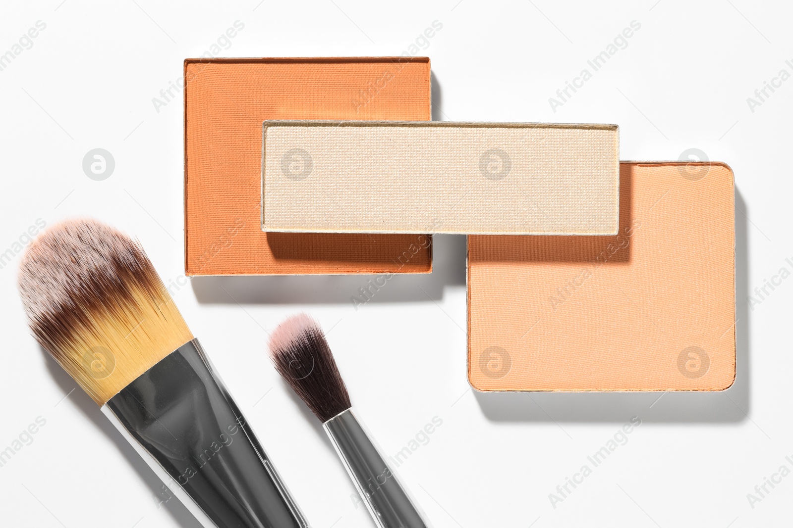 Beautiful eyeshadow refill pans and brushes on white background, flat lay Photo of Beautiful eyeshadow refill pans and brushes on white background, flat lay