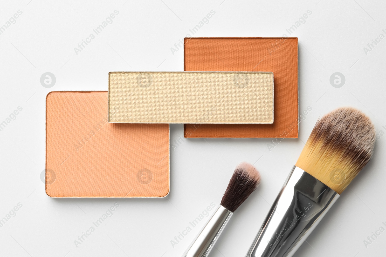 Beautiful eyeshadow refill pans and brushes on white background, flat lay Photo of Beautiful eyeshadow refill pans and brushes on white background, flat lay