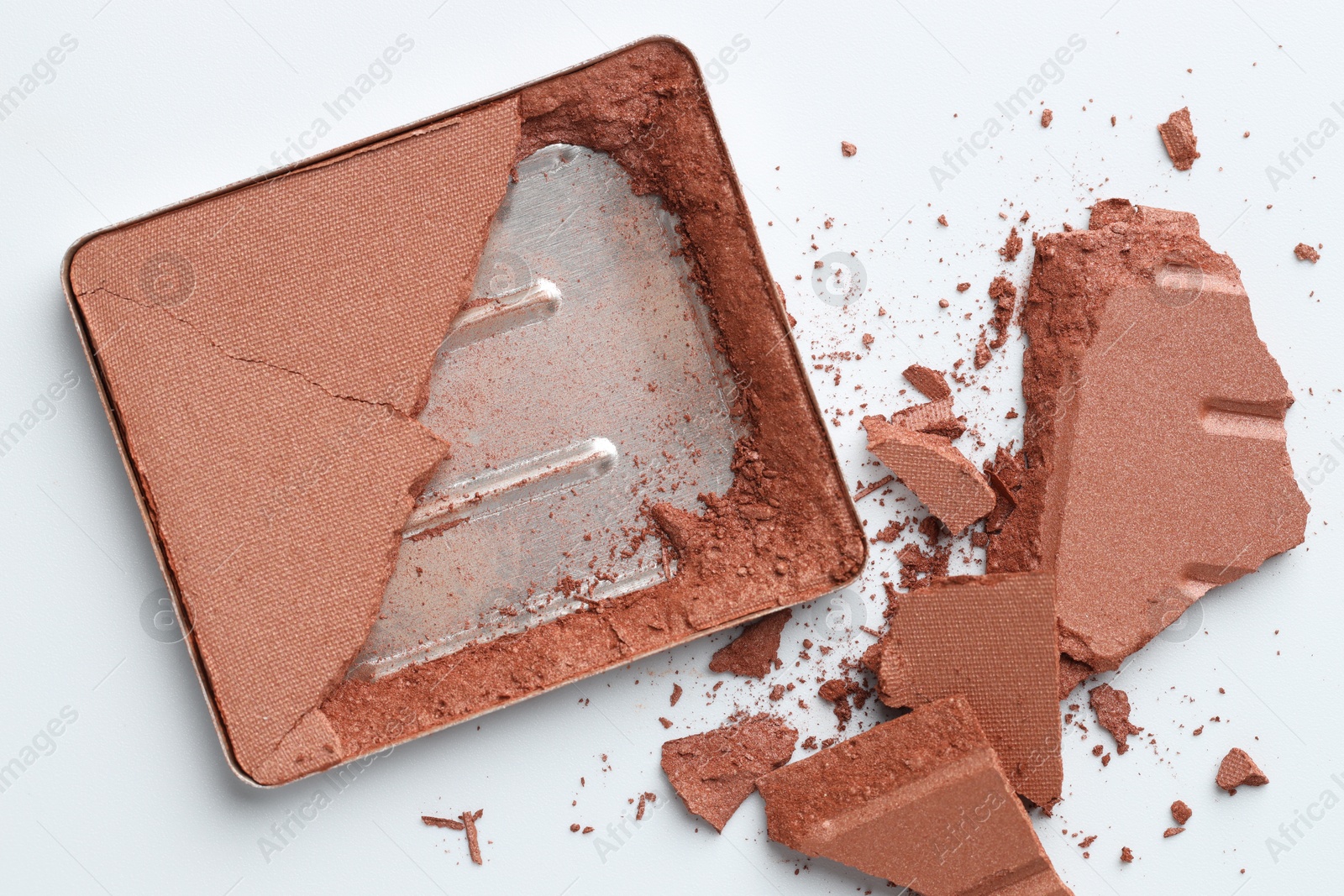 Broken eyeshadow refill pan on white background, top view Photo of Broken eyeshadow refill pan on white background, top view
