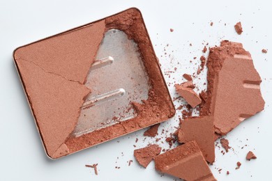 Photo of Broken eyeshadow refill pan on white background, top view