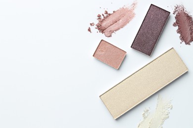 Photo of Beautiful eyeshadow refill pans on white background, flat lay. Space for text