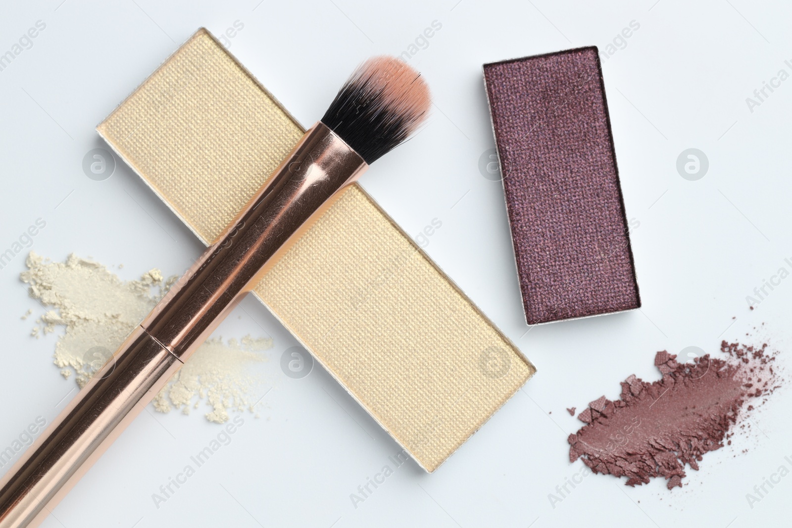 Beautiful eyeshadow refill pans and brush on white background, flat lay Photo of Beautiful eyeshadow refill pans and brush on white background, flat lay