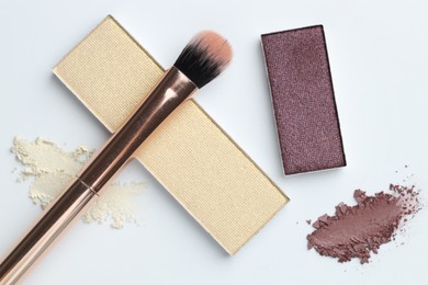 Photo of Beautiful eyeshadow refill pans and brush on white background, flat lay