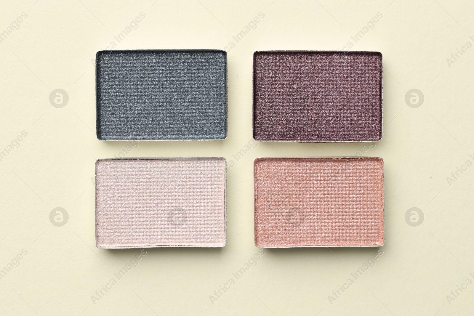 Beautiful eyeshadow refill pans on beige background, flat lay Photo of Beautiful eyeshadow refill pans on beige background, flat lay
