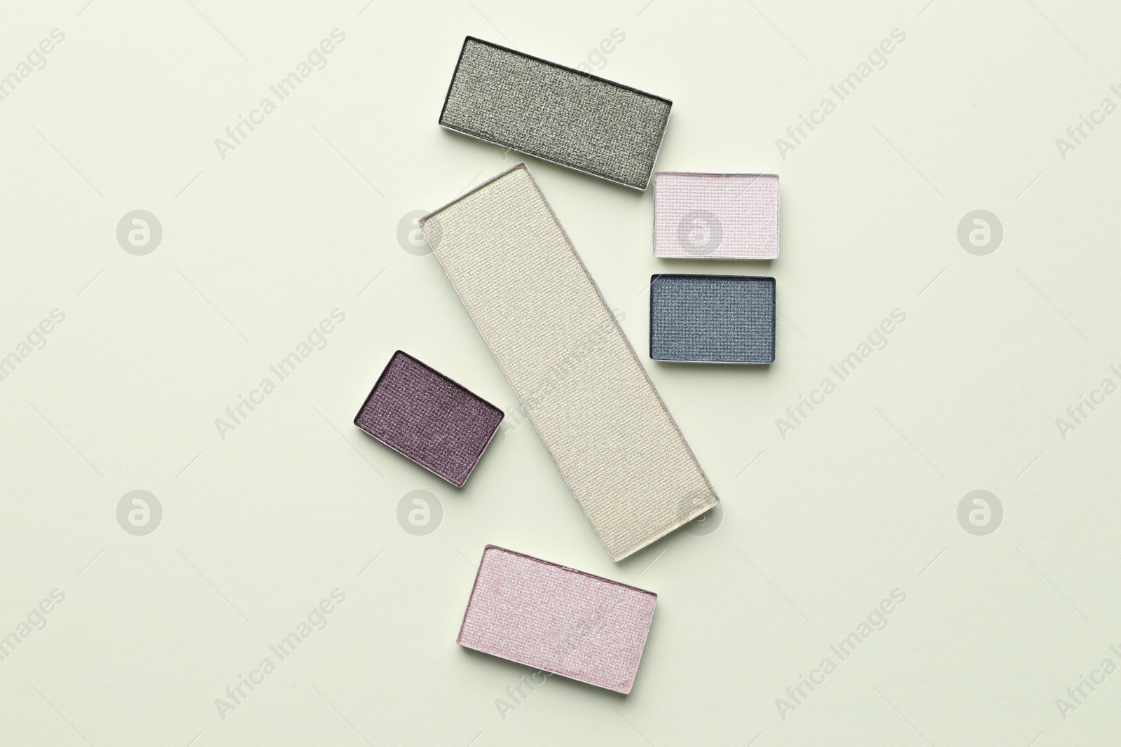Beautiful eyeshadow refill pans on beige background, flat lay Photo of Beautiful eyeshadow refill pans on beige background, flat lay