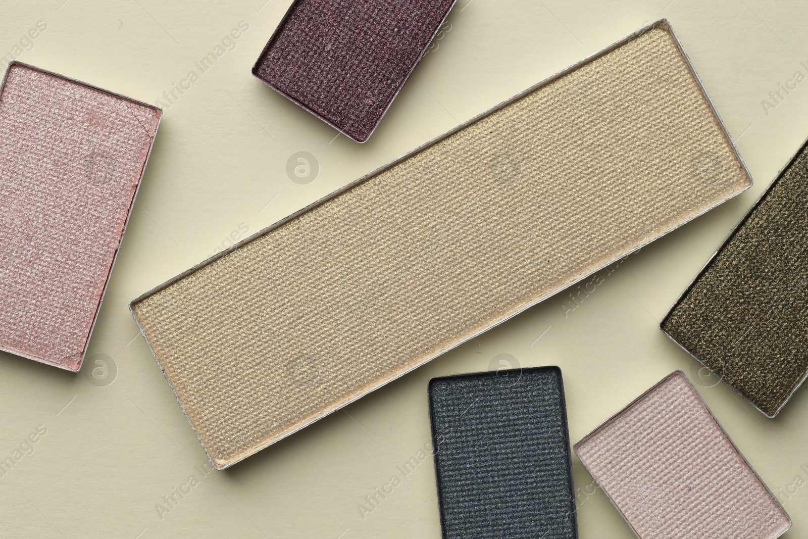 Beautiful eyeshadow refill pans on beige background, flat lay Photo of Beautiful eyeshadow refill pans on beige background, flat lay