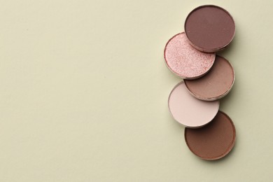 Photo of Beautiful eyeshadow refill pans on beige background, flat lay. Space for text