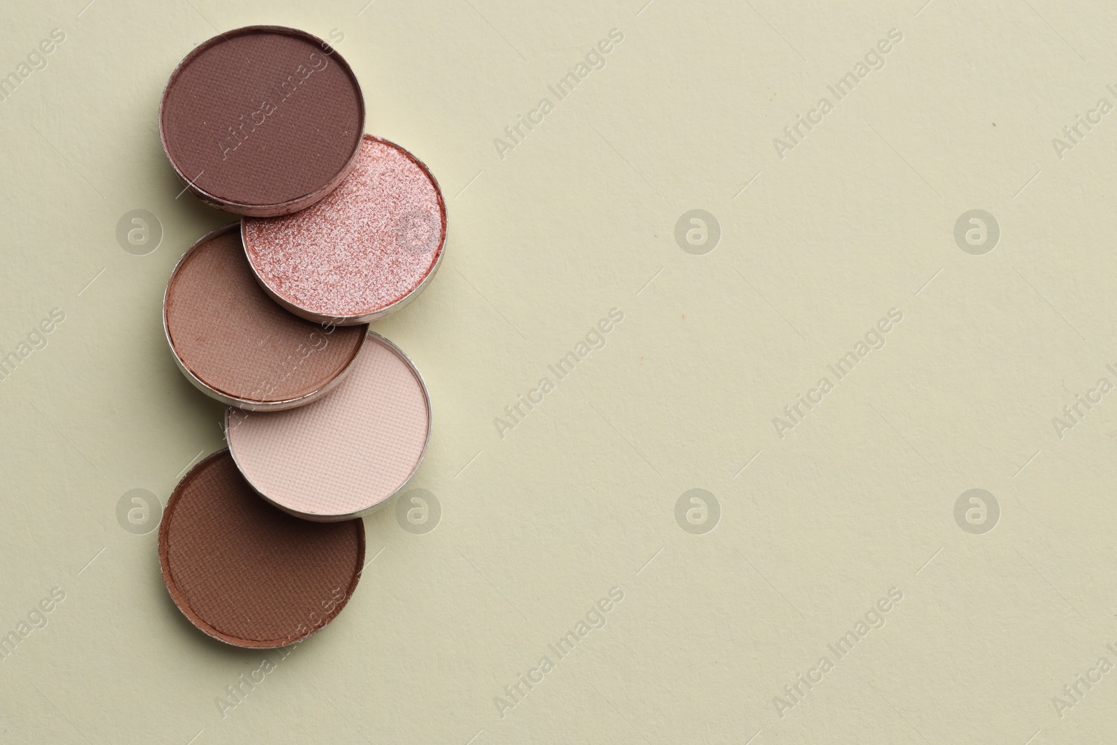 Beautiful eyeshadow refill pans on beige background, flat lay. Space for text Photo of Beautiful eyeshadow refill pans on beige background, flat lay. Space for text