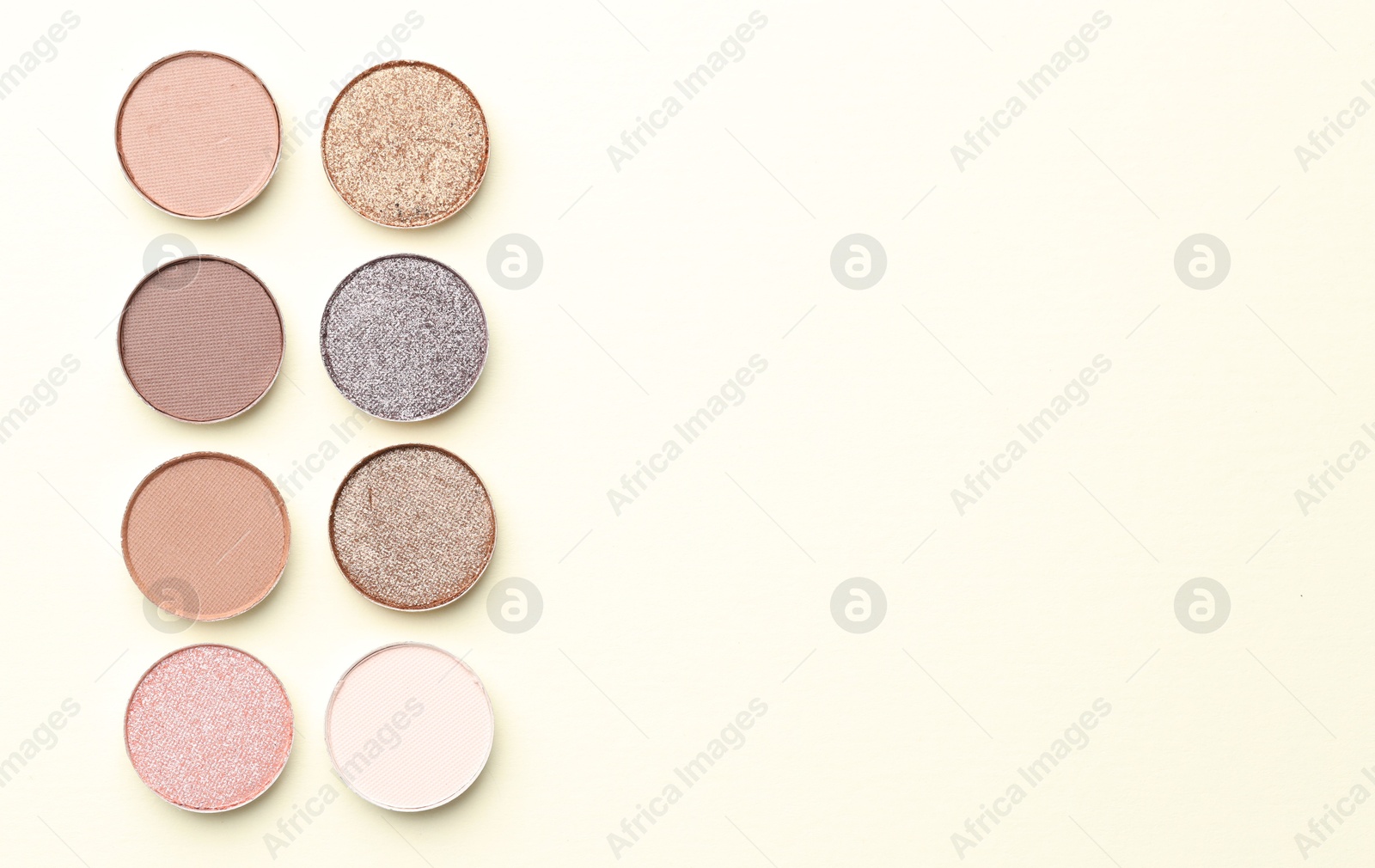 Beautiful eyeshadow refill pans on beige background, flat lay. Space for text Photo of Beautiful eyeshadow refill pans on beige background, flat lay. Space for text
