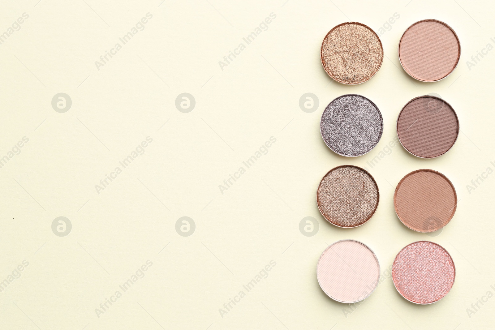 Beautiful eyeshadow refill pans on beige background, flat lay. Space for text Photo of Beautiful eyeshadow refill pans on beige background, flat lay. Space for text