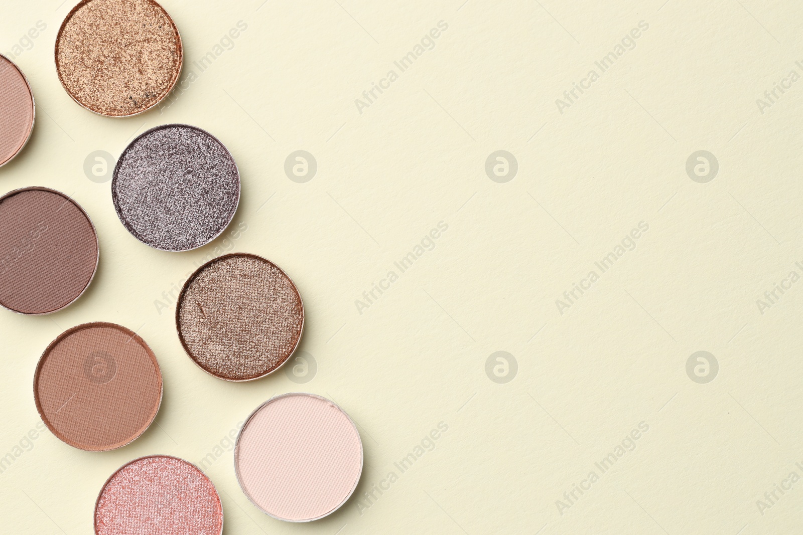 Beautiful eyeshadow refill pans on beige background, flat lay. Space for text Photo of Beautiful eyeshadow refill pans on beige background, flat lay. Space for text