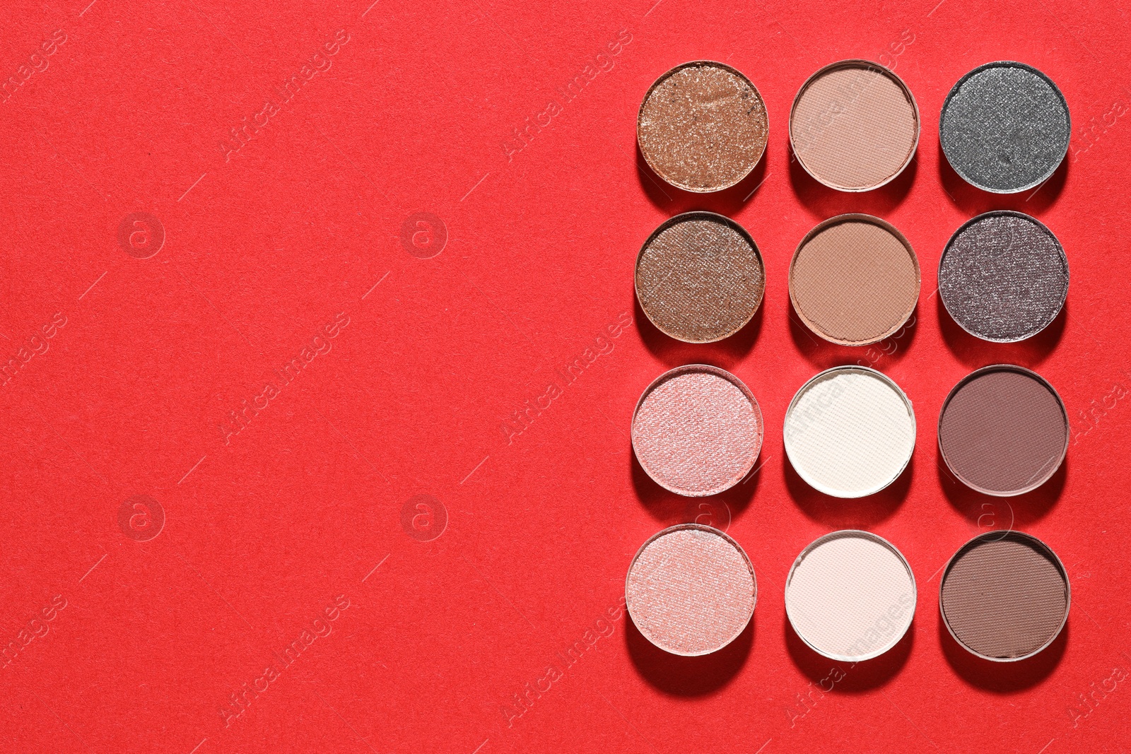 Beautiful eyeshadow refill pans on red background, flat lay. Space for text Photo of Beautiful eyeshadow refill pans on red background, flat lay. Space for text