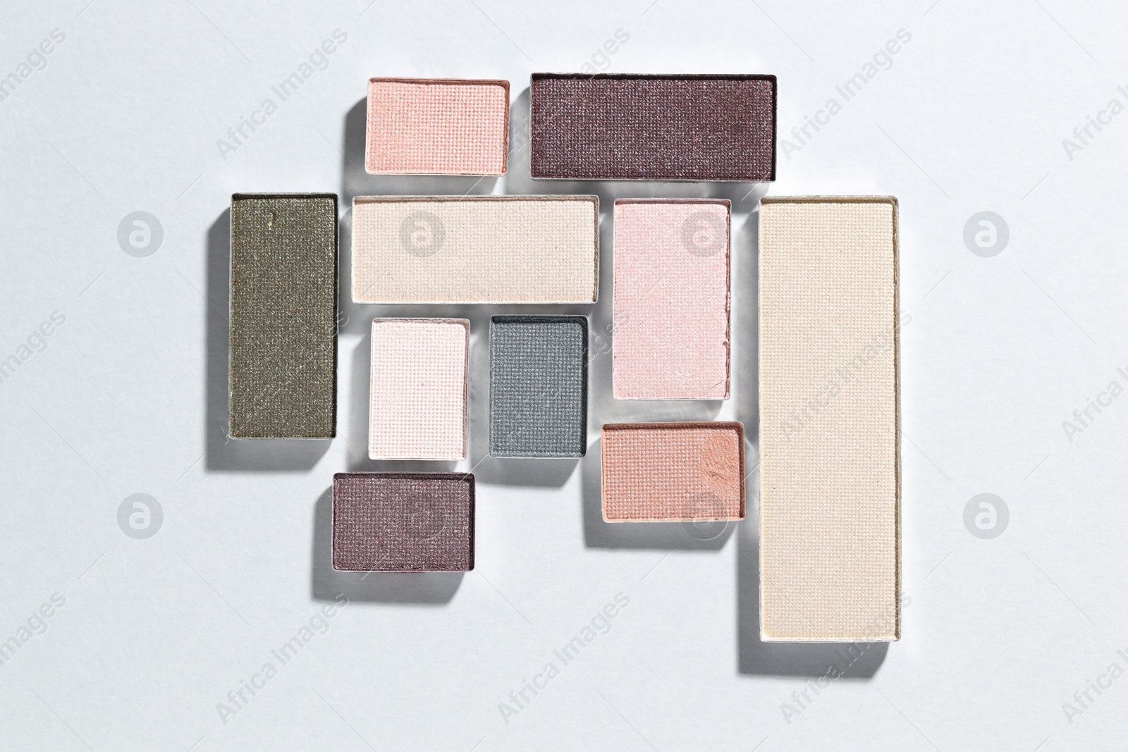 Beautiful eyeshadow refill pans on light background, flat lay Photo of Beautiful eyeshadow refill pans on light background, flat lay