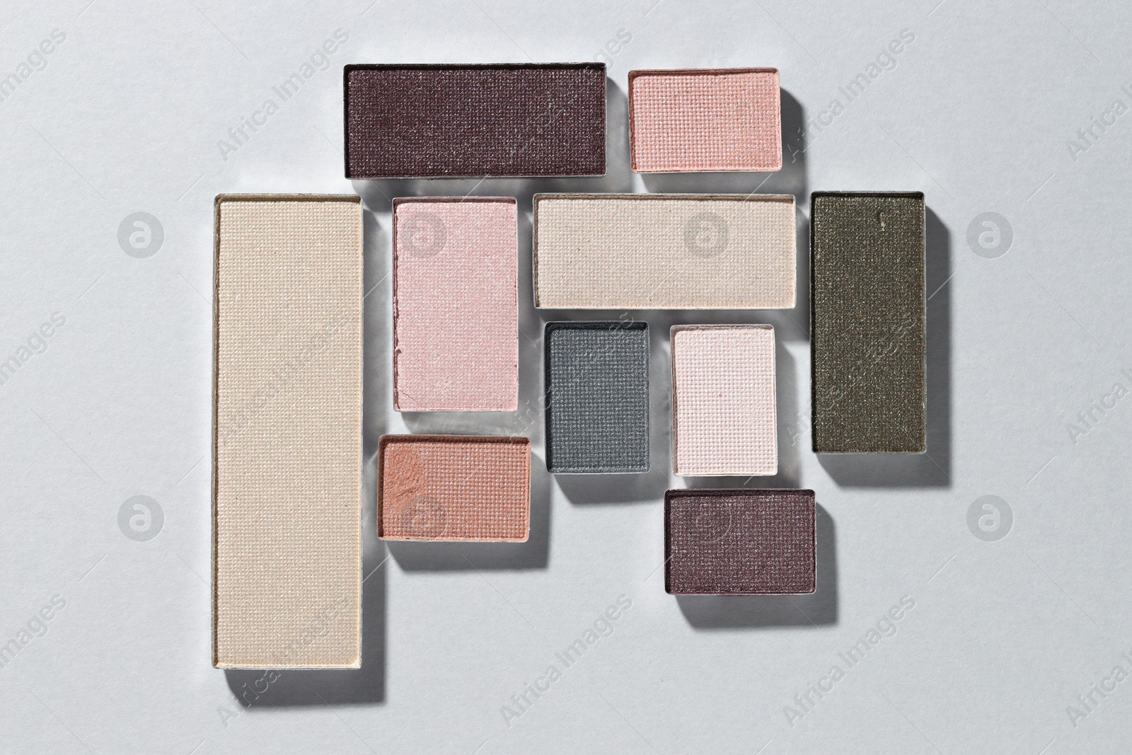 Beautiful eyeshadow refill pans on light background, flat lay Photo of Beautiful eyeshadow refill pans on light background, flat lay