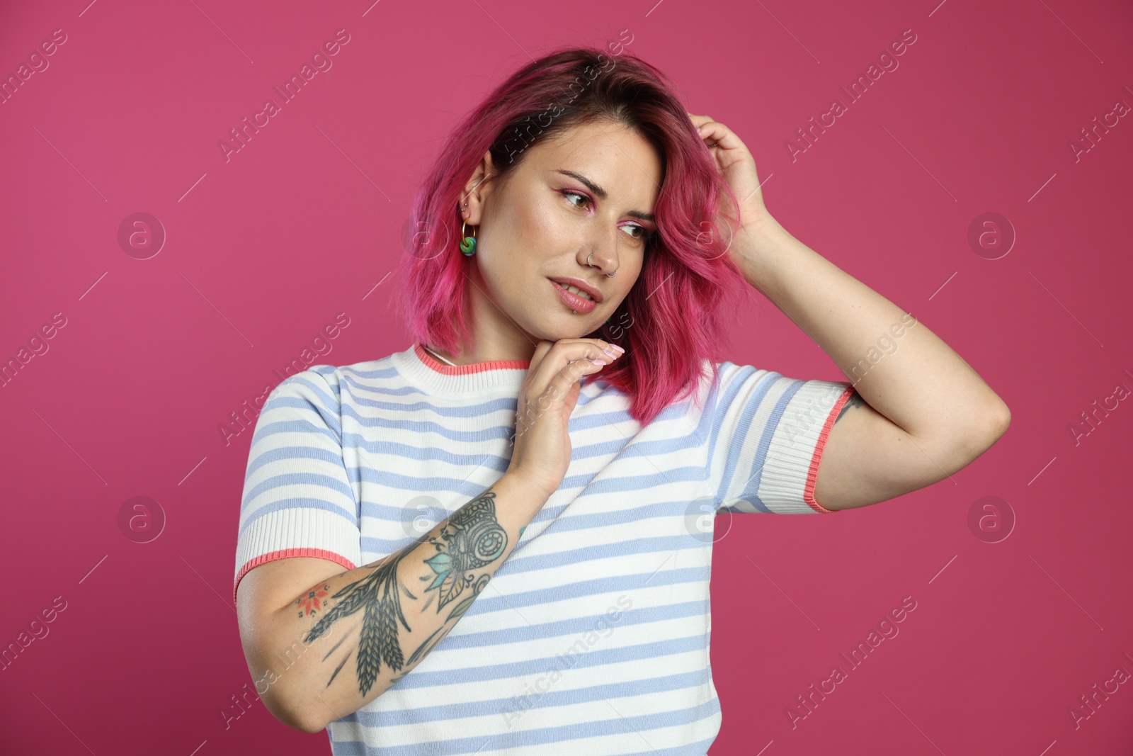 Beautiful woman with bright dyed hair on pink background Photo of Beautiful woman with bright dyed hair on pink background
