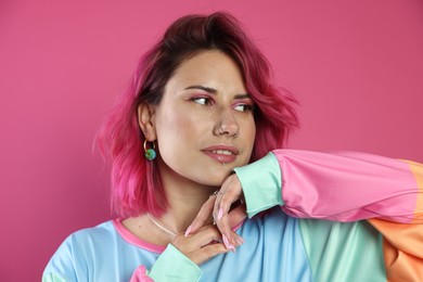 Photo of Beautiful woman with bright dyed hair on pink background
